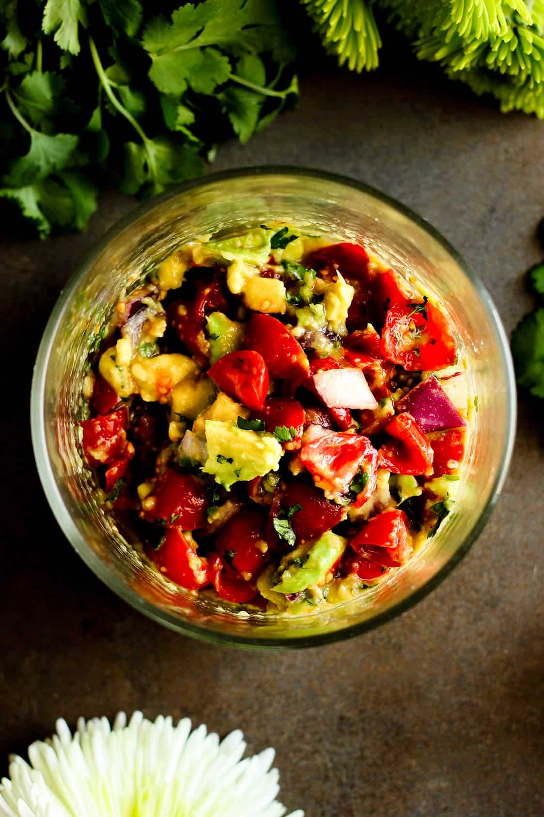 ingredients combined for tomato avocado salad