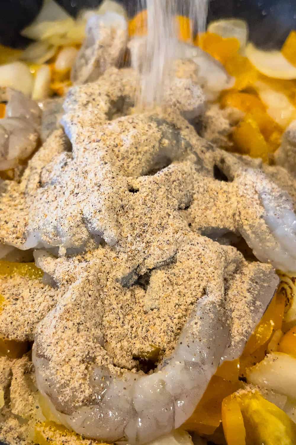 shrimp being seasoned with fajita seasoning