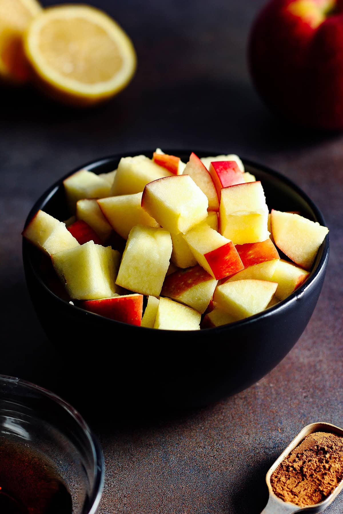 ingredients for dairy-free stewed apples including apples, cinnamon, mapple syrup, and lemon juice