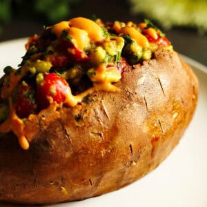 taco stuffed sweet potatoes with avocado salad and chipotle sauce